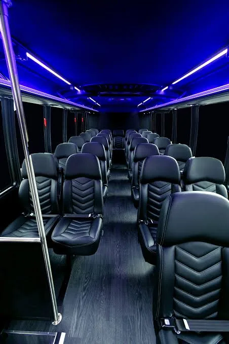 Leather seating and wide aisle inside a 27 passenger executive shuttle bus