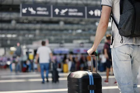 Travelers with luggage for an airport group bus transfer