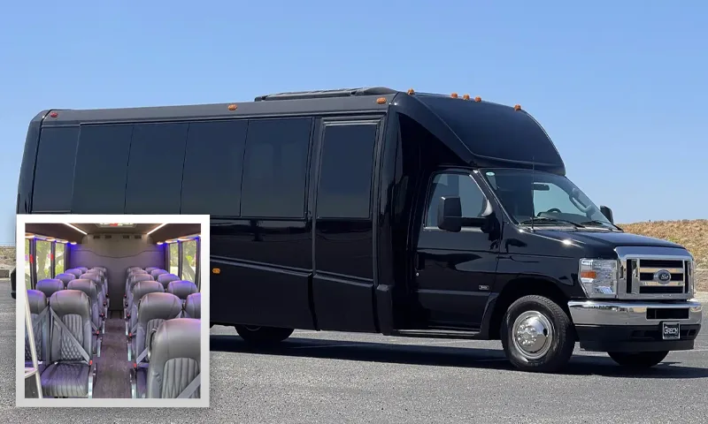Black executive shuttle bus with a view of its leather seating interior
