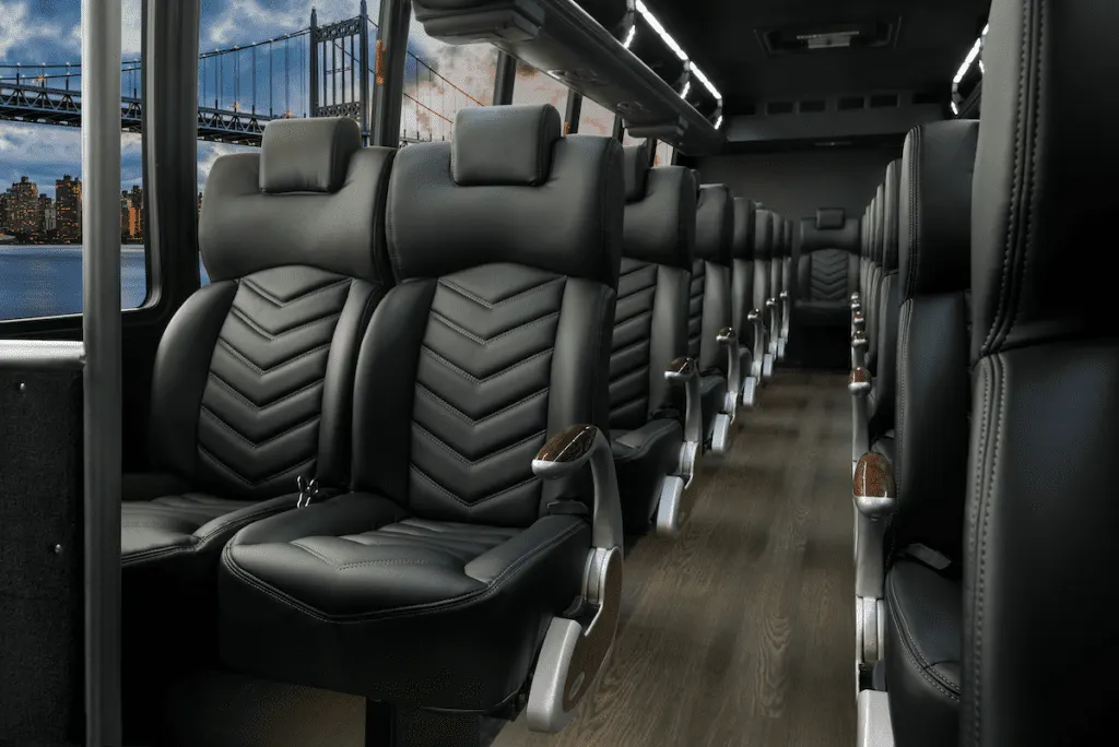 Executive shuttle bus interior with leather seats for employee and conference shuttles