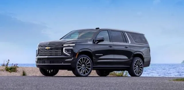 Black Chevy Suburban executive SUV parked by the water