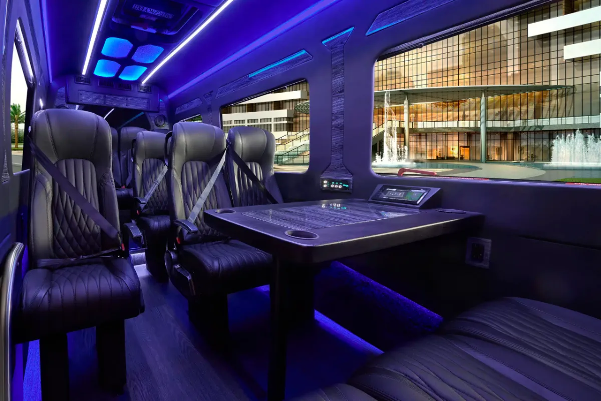 Executive Sprinter cabin with blue ambient lighting, leather seats and a meeting table