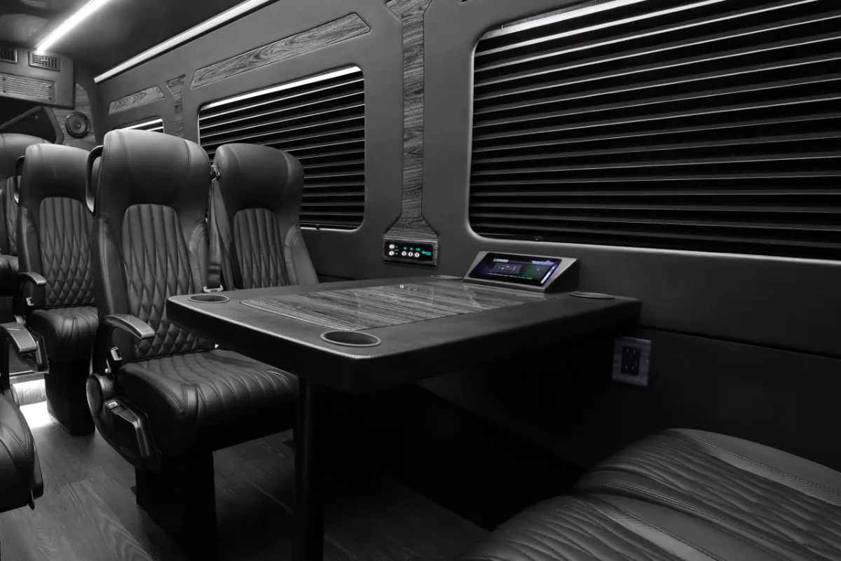 Executive Sprinter interior with leather captain chairs around a conference table