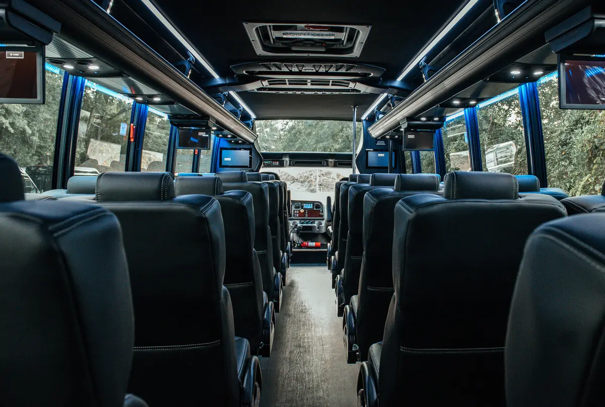 Motor coach cabin with high-back seats and overhead luggage racks